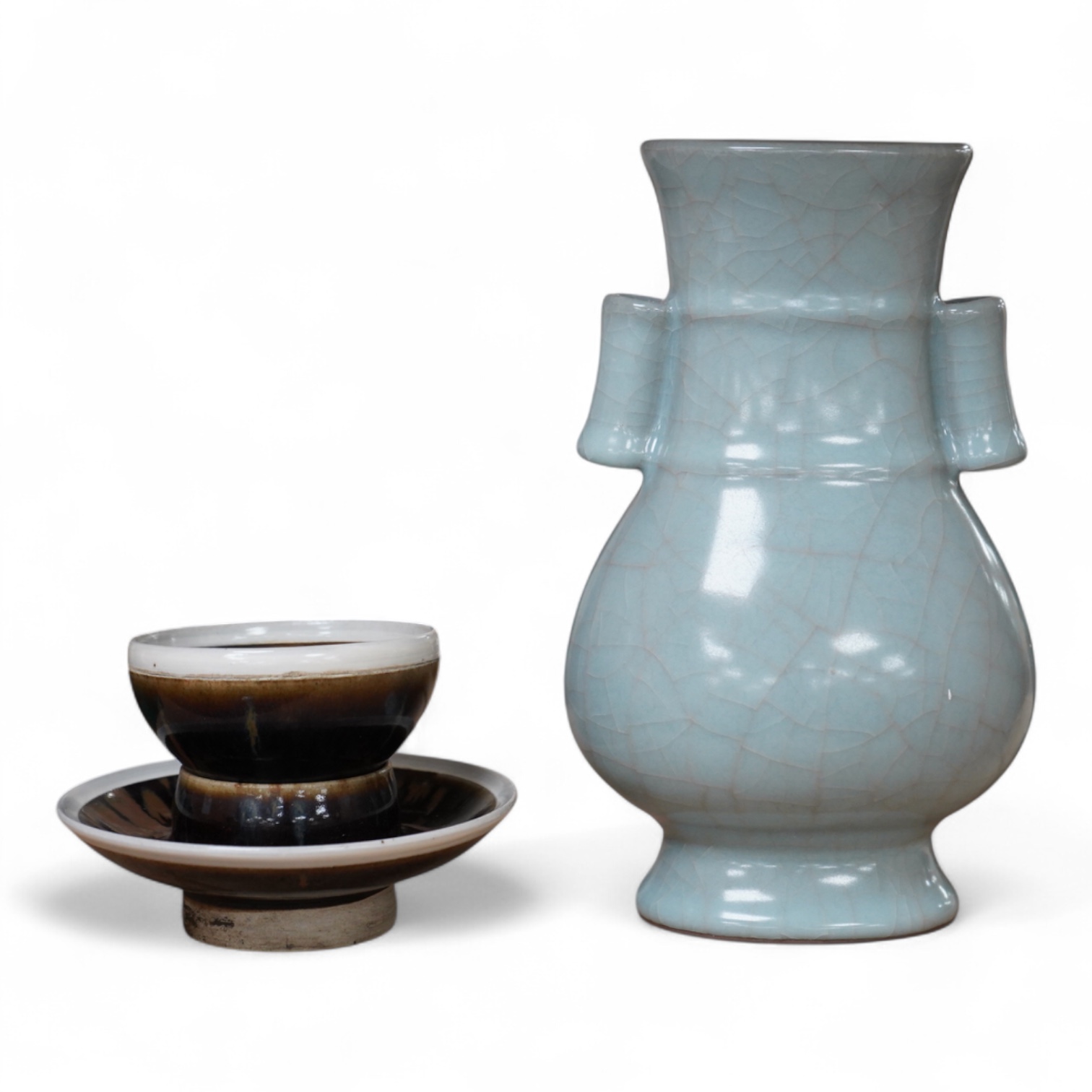 A Chinese crackle glaze arrow vase and a black and russet glazed tea bowl on stand, largest 22cm high
